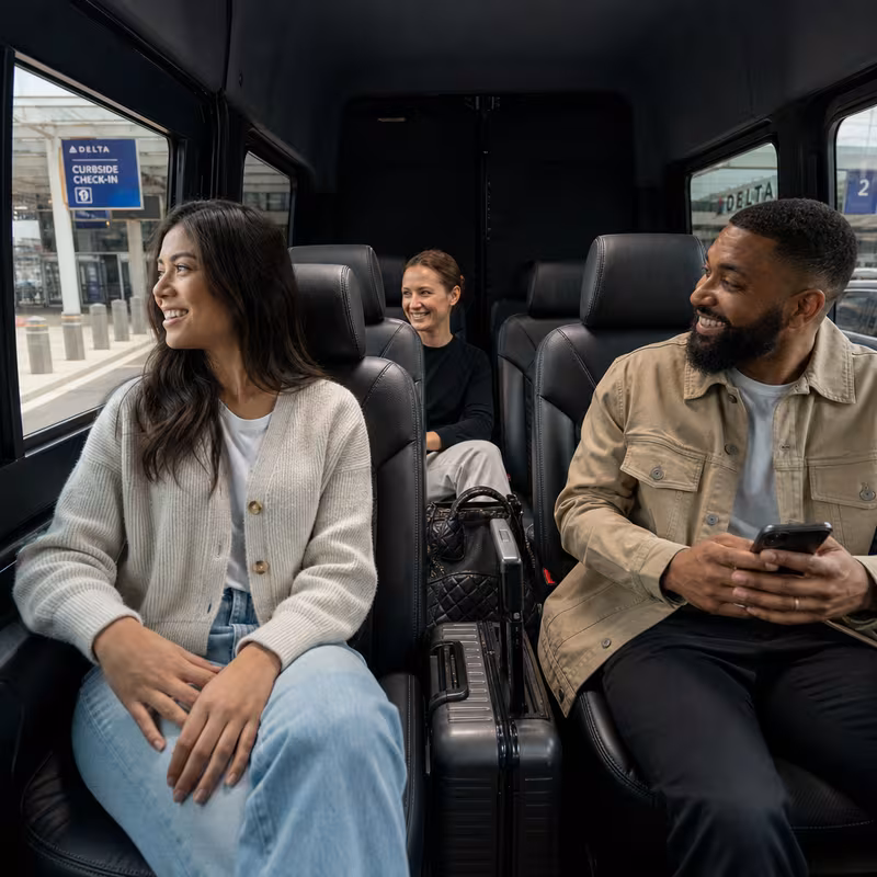 Passengers loading luggage while boarding an Detroit group shuttle