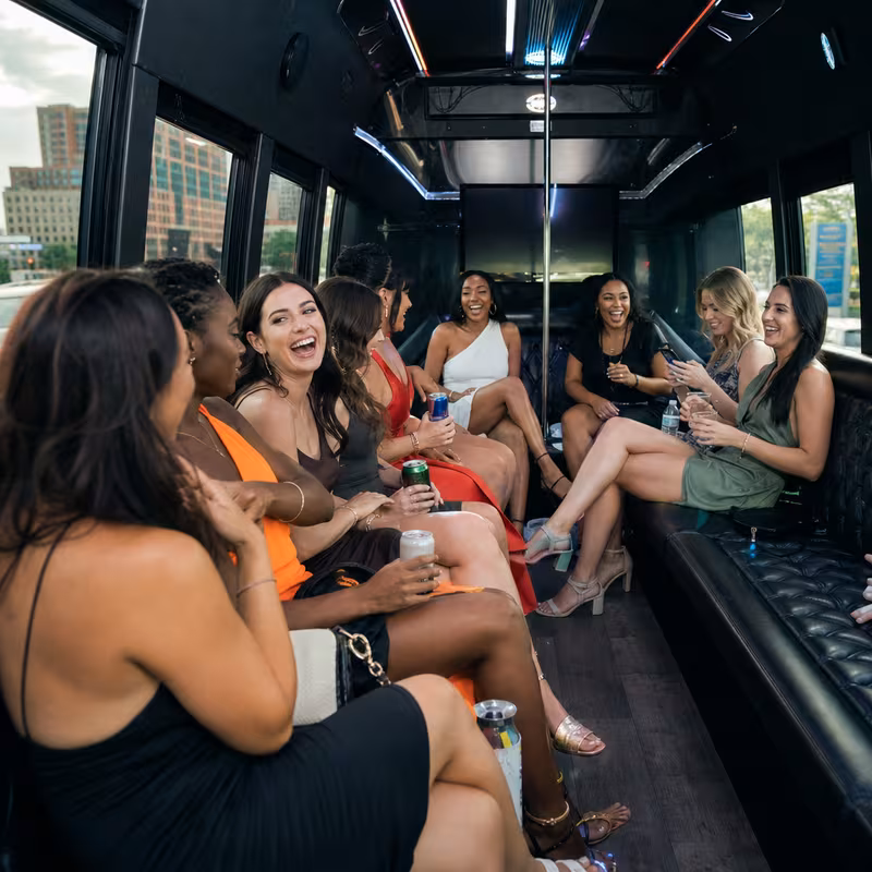 Party bus interior with wraparound leather seating and LED lighting in Detroit