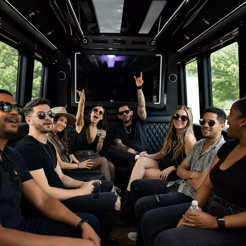Group boarding a white charter bus for Concert Transportation transportation in Detroit