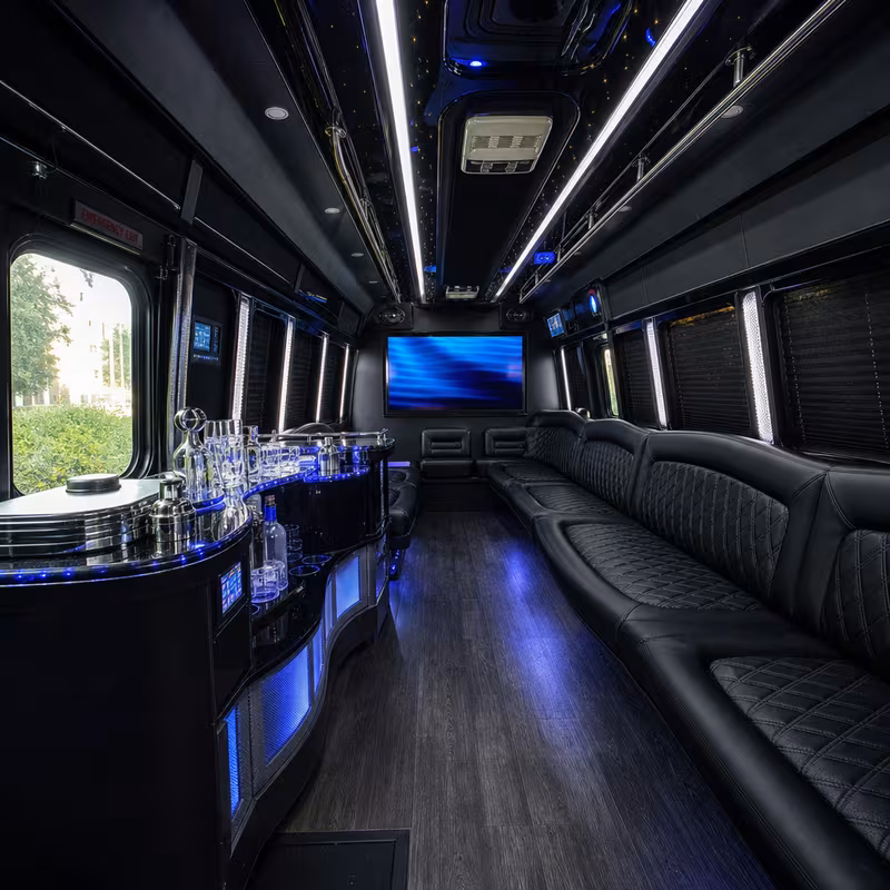 Party bus interior with wraparound leather seating and LED lighting in Detroit
