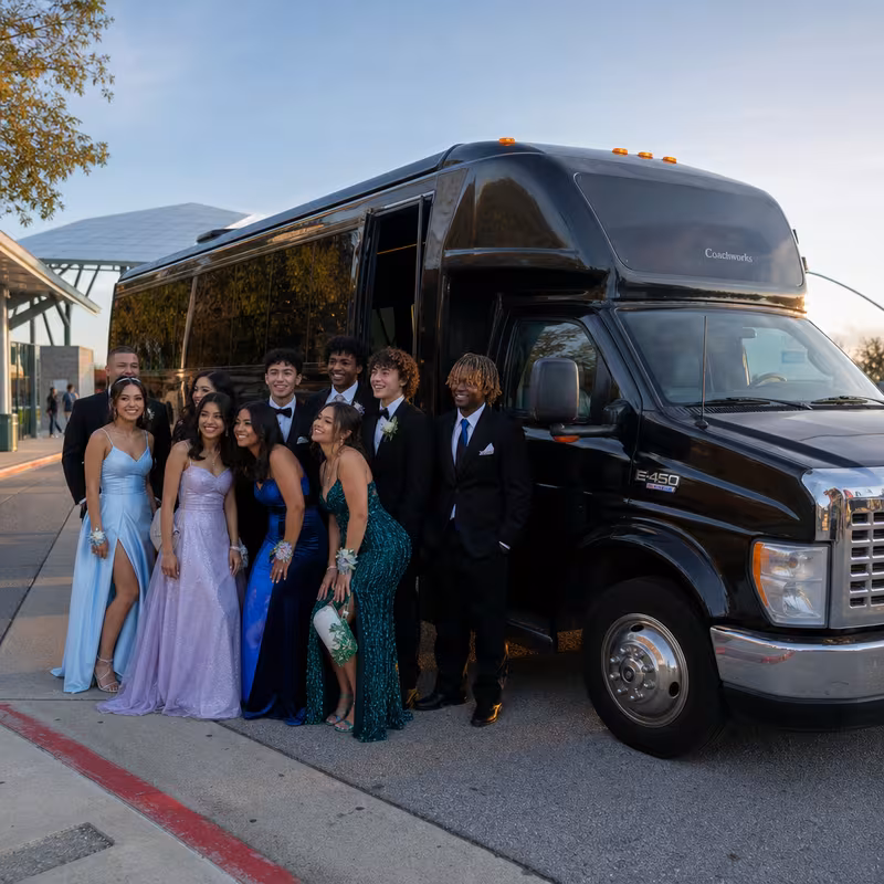 Group boarding a white charter bus for Prom & Homecoming Transportation transportation in Detroit