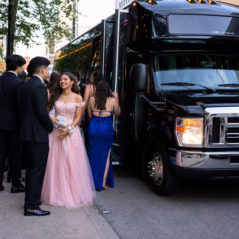 Passengers loading luggage while boarding an Detroit group shuttle